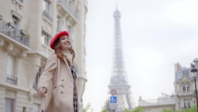 Cinematic footage of a young woman wearing fashionable clothes having fun in Paris at the eiffel tower park and  streets. Concept about european tourism and travels to the capital cities