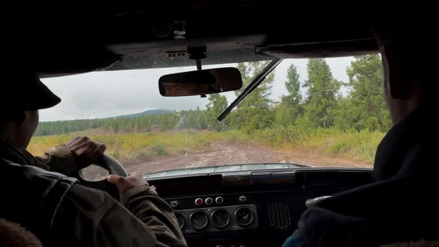 View from the cab of the car to forest in Altai, Siberia, Russia. Beautiful summer nature landscape at during daytime