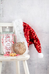 Obraz premium Christmas Decoration, Santa Claus Hat And Wooden Chair.