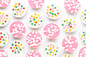 Fototapeta premium Colorful cupcakes on a white background.