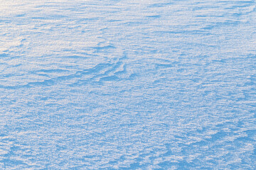 Close-up of fresh shiny snow on the ground on a sunny day. Good as a winter season background. Copy space.