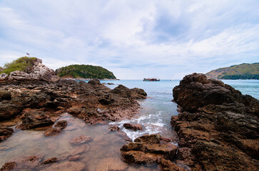 Fototapeta na wymiar Beautiful landscape with sea, rock, stones and cloudy sky.