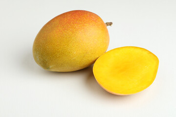 Mango fruit with mango slice placed on a white background