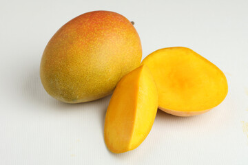 Mango fruit with mango slice placed on a white background