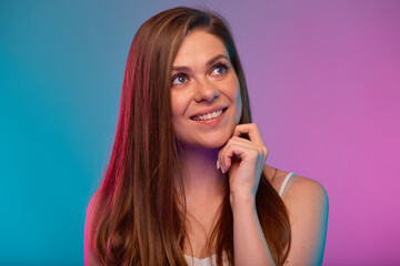 Smiling woman looking up face portrait with neon lights colors effect. Girl isolated on neon background.