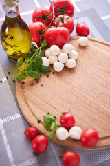 Ingredients for Caprese salad - Mini mozzarella cheese in glass bowl, tomato and basil