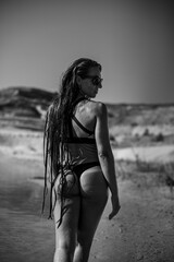 Sports girl on the beach in a swimsuit. Black&white