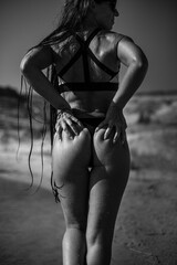 Sports girl on the beach in a swimsuit. Black&white