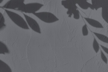 Abstract tree leaves shadows on gray concrete wall texture with roughness and irregularities. Abstract trendy colored nature concept background. Copy space for text overlay, poster mockup flat lay 