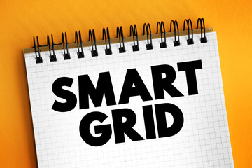 Smart grid - electrical grid which includes a variety of operation and energy measures, text quote concept on notepad
