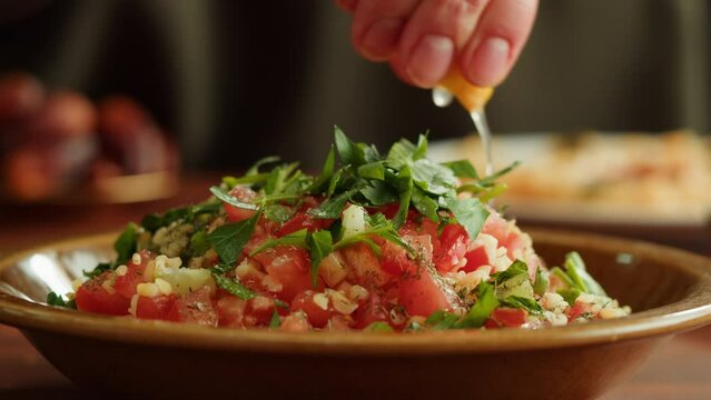 Tabbouleh Vegetable Salad close-up, middle eastern national traditional food. Muslim family dinner, Ramadan, iftar. Arabian cuisine.