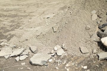 Stones on asphalt. Broken stone on street. Ruined structure.