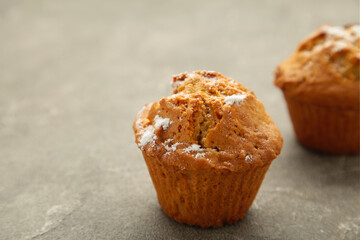 Vanilla muffins. Sweet cupcakes on grey background. Top view.