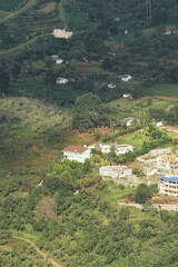 Fototapeta na wymiar birds eye view of lush green palani foothills and mountain village near kodaikanal hill station in tamilnadu, south india