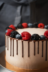 cake with chocolate and berries close-up.