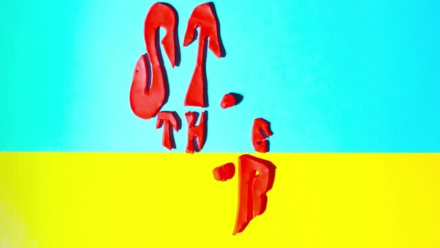 Plasticine claymotion stopmotion animation with call stop war in Ukraine, a bullet flying against the background of the flag of Ukraine and a white pigeon or dove of peace with a twig in beak.