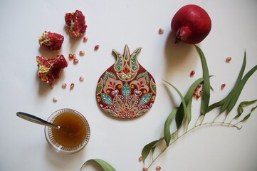 Rosh Hashanah Concept (Jewish New Year). Traditional symbols - pomegranate, honey and handmade...