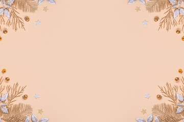 christmas or new year composition. christmas decorations in silver and gold colors on pastel beige background with empty copy space for text. top view