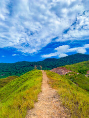 A road leading to the top of the mountains in the distance