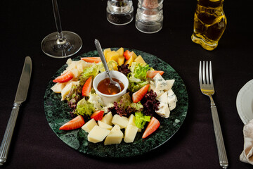 cheese plate with fruits and sauce