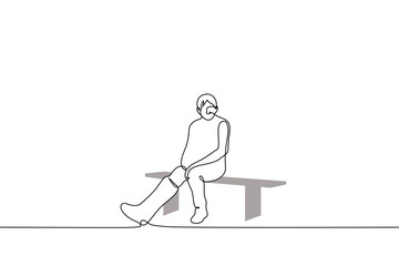 Fototapeta na wymiar man with a cast on his right leg sadly sits alone on a bench - one line drawing vector. concept an injured athlete sits idle, a man with a broken leg on which a plaster