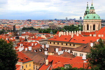 Fototapeta na wymiar Prague, Czech Republic. Mala Strana, Lesser Town of Prague. Top view of downtown, panorama, old buildings with red tiled roofs, church, tower, castle