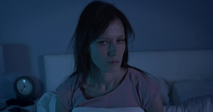 Woman try wake up and falls on pillow in bed at early morning, slow motion