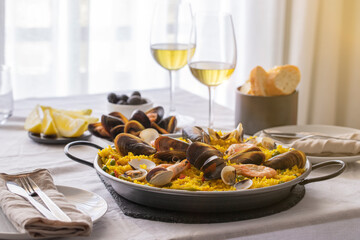 Typical Spanish dish seafood Paella made with prawns, clams and mussels on saffron rice with...