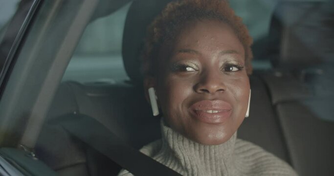 Black Woman Is Looking Through The Passenger Window In A Car And Singing