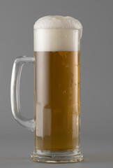 Mug with beer on gray background, close up