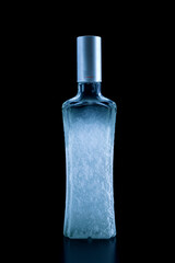 Frozen bottle of vodka close-up on a black background