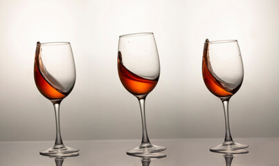 three falling glasses with red wine, motion blur, blur