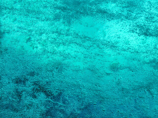 Turquoise texture of boiling water. Natural empty aqua background with air bubbles