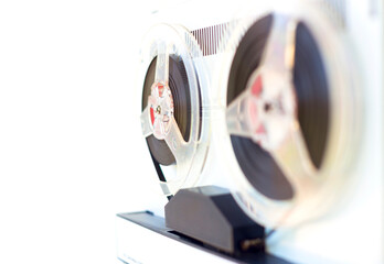 old-style reel-to-reel tape recorder, close-up on a white background