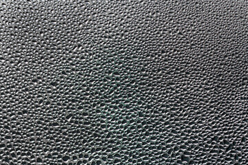 Background photo of water droplets on a glass plate.