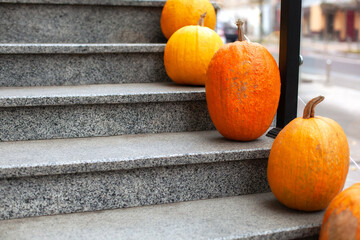 Residential house decorated for Halloween holiday. Different colored pumpkins in front door On...