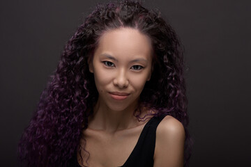 Fototapeta premium Portrait of young asian woman with curly hair