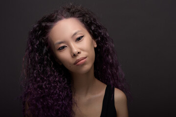 Fototapeta premium Portrait of young asian woman with curly hair