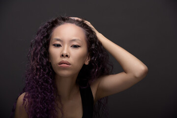 Fototapeta premium Portrait of young asian woman with curly hair