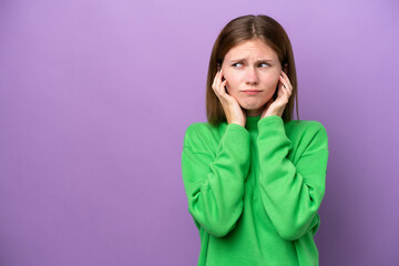 Young English woman isolated on purple background frustrated and covering ears