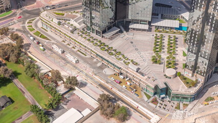 Obraz premium Bussy traffic on the road and intersection in Dubai downtown aerial timelapse.