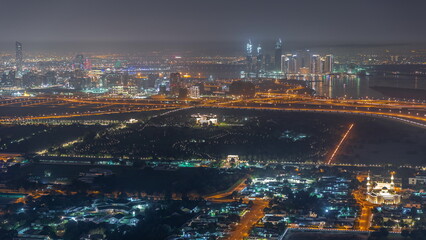 Garden in Zabeel district with skyscrapers on a background aerial night timelapse in Dubai, UAE