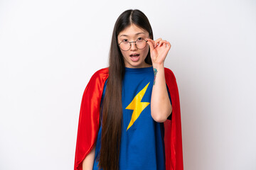 Super Hero Chinese woman isolated on white background with glasses and surprised © luismolinero