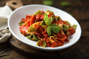 Multi colored pasta with tomato and basil