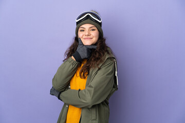 Teenager Russian girl with snowboarding glasses isolated on purple background happy and smiling