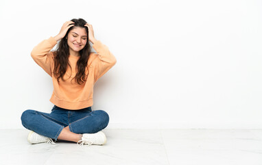 Teenager Russian girl sitting on the floor laughing