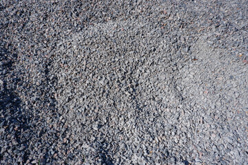Gravel texture. Fine and large gray granite stone gravel.