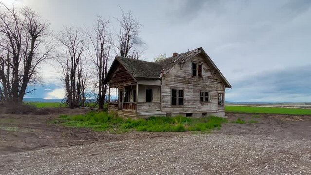 Old abandoned farmhouse. Creepy spooky murder house concept. Zoom in shot.