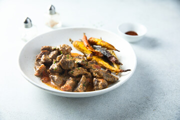 Homemade meat ragout with roasted carrots