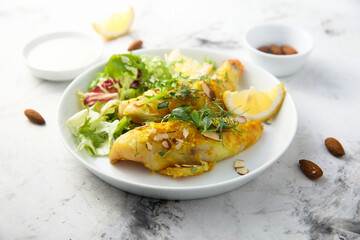 Roasted fish with almond flakes